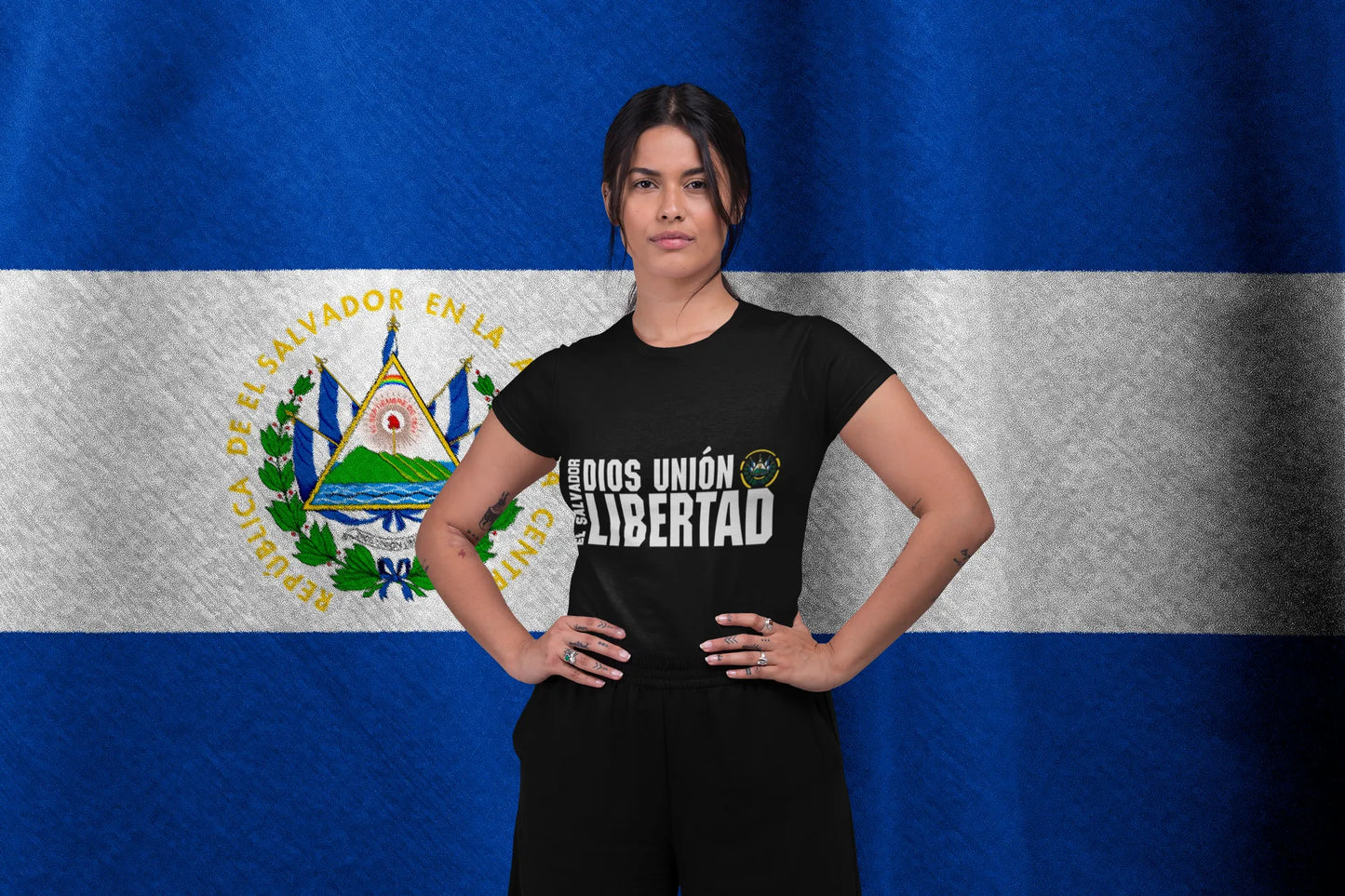 Woman wearing El Salvador National Motto 'Dios Unión Libertad' T-Shirt, featuring the coat of arms, promoting Patriotic El Salvador Clothing.