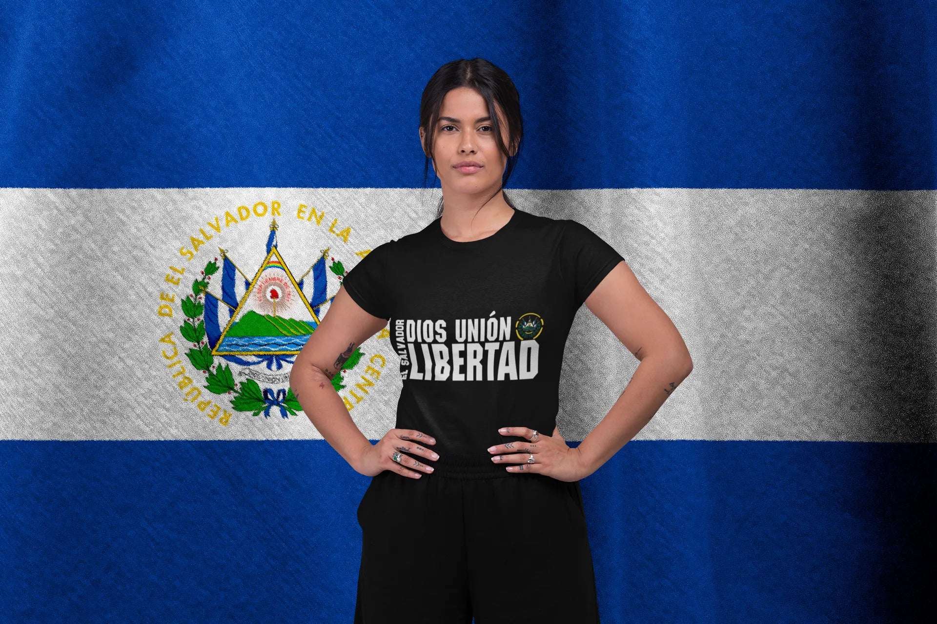 Woman wearing El Salvador National Motto 'Dios Unión Libertad' T-Shirt, featuring the coat of arms, promoting Patriotic El Salvador Clothing.
